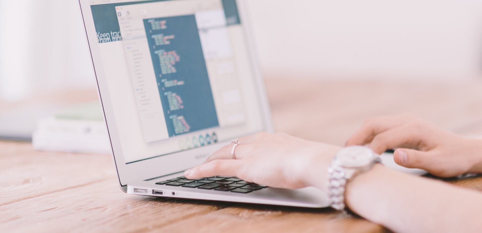 married woman with nice watch working on laptop